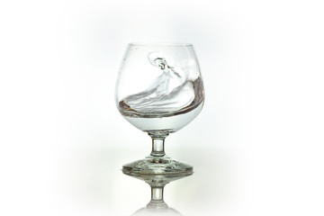 Water spray in wineglass. Water splash.