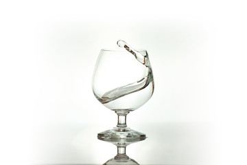 Water spray in wineglass. Water splash.