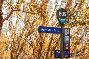 Ponts des Arts (Bridge of Arts) bus stop sign in Paris, France. Yellow leaves tree in autumn.