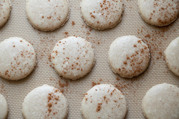 Baked Cinnamon Macaron Cookie Shells Light and delicate cookies made from egg whites and almond flour dusted with cinnamon and baked to perfection.