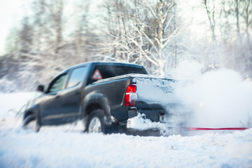 Process of taking out suv car stuck in snow, men digging and pushing the car out of snow, concept of winter problems with car