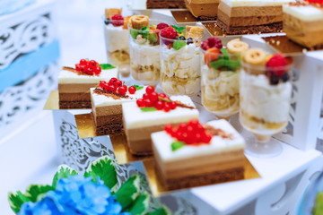 cupcakes decorated with berries and ice cream on stand