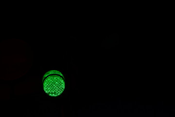  Green traffic signal. Green man on black background