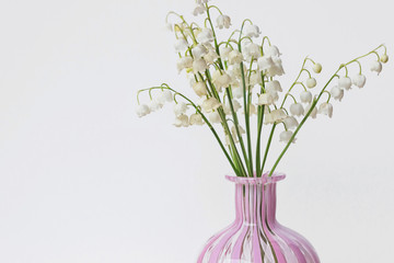 lily of valley/Convallaria majalis flowers bouquet in vase on white background 