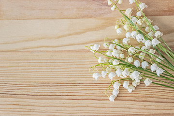 lily of valley flowers bouquet on wooden background 