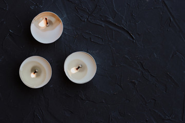 Burning candles on a black background