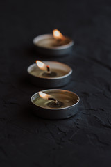 Burning candles on a black background