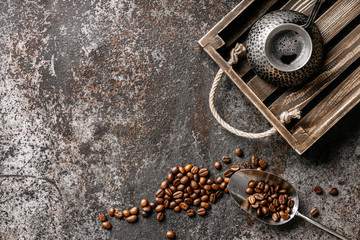 Coffee on wooden tray with coffee beans on dark textured background. Top view with copy space. Background with free text space.