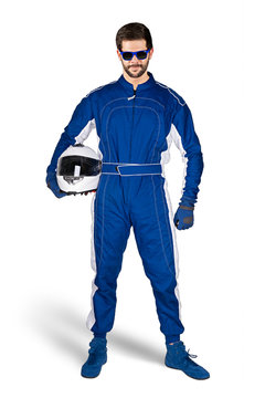 Race driver in blue white motorsport overall shoes gloves and safety gear crash helmet under his arm determined and ready to go isolated white background. Car racing motorcycle sport concept.
