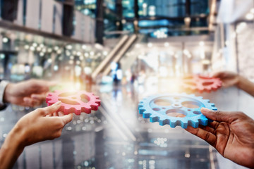 Business team connect pieces of gears. Teamwork, partnership and integration concept. double...