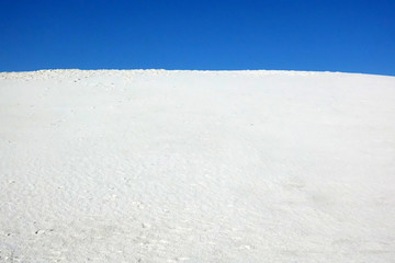 The blue horizon under sand in White Sands, New Mexico.
