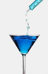 blue cocktail with water splash isolated on white