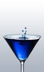 splashy martini with blue drops