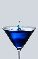 blue cocktail with splash isolated on white