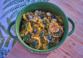 Fried dandelion flowers in a green bowl