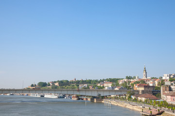 Fototapeta na wymiar View of Sava river bank in Belgrade. An orthodox cathedral church can be seen on the right, Kalemegdan fortress on the background, and brankov most bridge in front