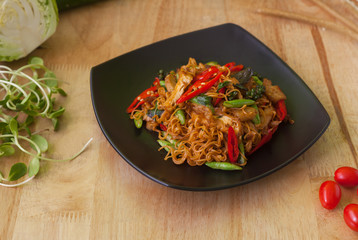 Vegetarian thai food,stir-fried rice noodles spicy ,on wooden background