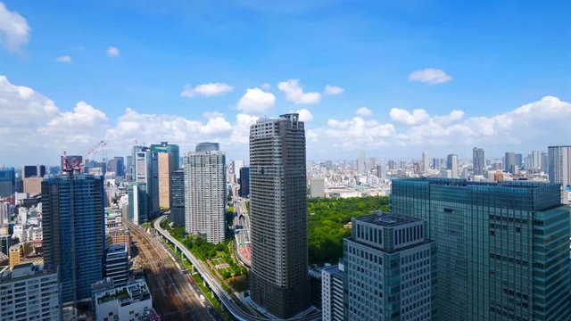 Time-lapse of the moving clouds and blue skies over the skyscrapers of the city of Tokyo, Japan
