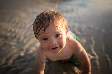 Toddler enjoying the beach at sunset