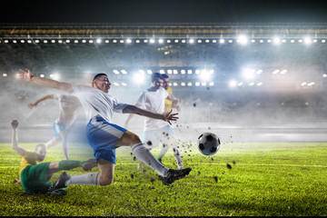 Obraz na płótnie Canvas Soccer players on stadium in action. Mixed media