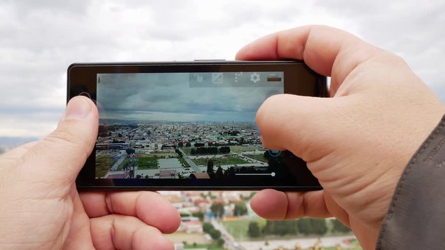 Capturing the panoramic beauty of Cholula in Puebla with a smartphone during a cloudy afternoon