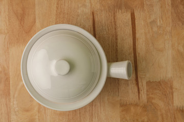 Fototapeta na wymiar ceramic pot,casserole on wooden background top view