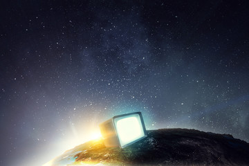 Vintage television set turned on against space background