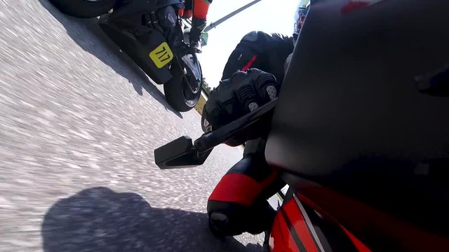 Motorcycle racer passes opponent on right turn