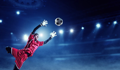 Soccer player on stadium in action. Mixed media