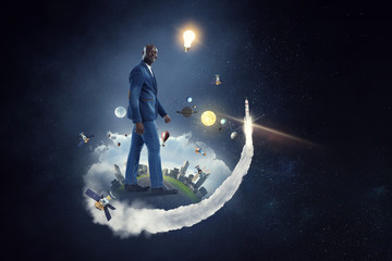 Obraz na płótnie Canvas Joyful black man wearing casual clothes running in space. Mixed media