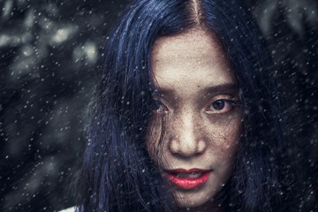 Close-up photos of a woman face with freckles The eyes look uncompromising.