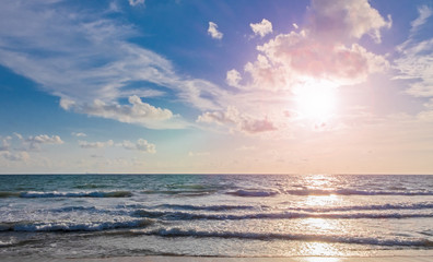 Splashes of fresh foaming, bubbling sea water, clear sky there are cloud and sunshine