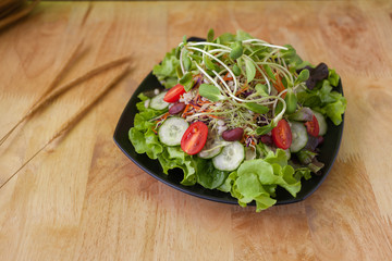  vegetarian salad with vegetables organic on dish.