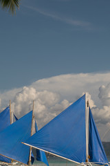 Blue sails with fluffy clouds