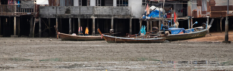 Fototapeta na wymiar A small fishing boat at a fishing village,long tail boat at Thailand