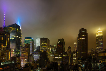 Fototapeta premium Aerial view of Manhattan illuminated skyscrapers, New York city at night