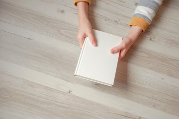 Obraz premium A person holding a book in his hand. 一冊の本を手に持つ人