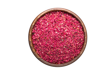 Dried sumac spice in wooden bowl, isolated on white background. Seasoning top view