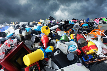 Pile of used Electronic and Housewares Waste Division broken or damage with sky and clouds are dark background, E-waste for Reuse and Recycle and is a problem with the environment concept.