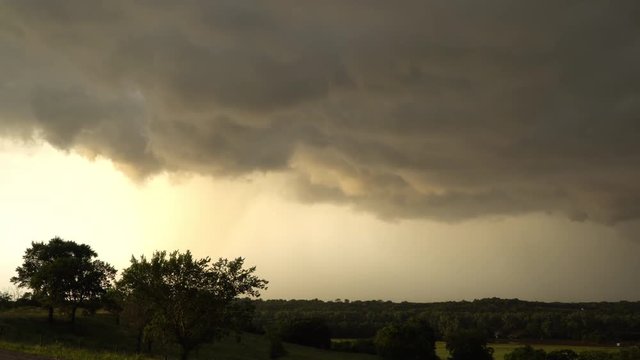 Clouds moving through the sky during severe thunderstorm in Oklahoma at sunset as the storm moves away.