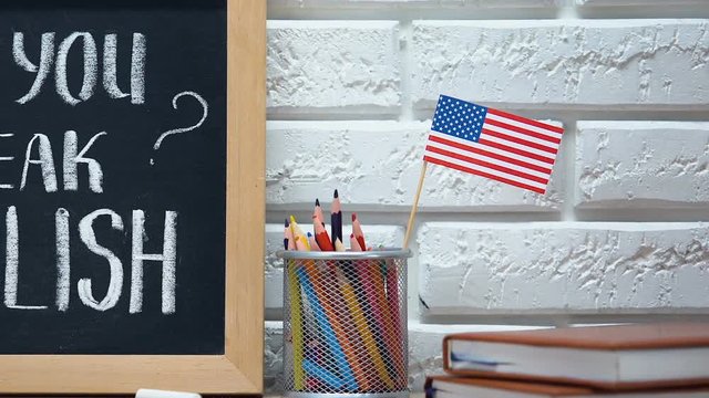 Do you speak English on blackboard, national flag in pen cup, language school