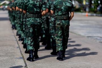 iron discipline of the best soldiers in army, a column of soldiers in uniform and with modern automatic weapons in hands of boots marching.