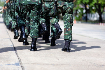 iron discipline of the best soldiers in army, a column of soldiers in uniform and with modern automatic weapons in hands of boots marching.