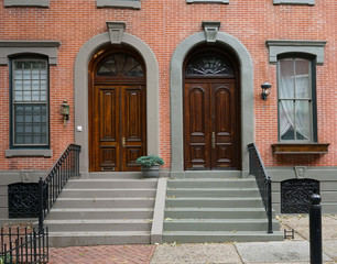 double wooden front doors of brick townhouses