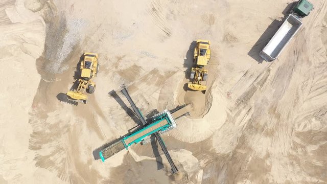 Mining industry. Process of sorting sand on mining conveyor belt. Sand moving on automated conveyor belt at sand quarry