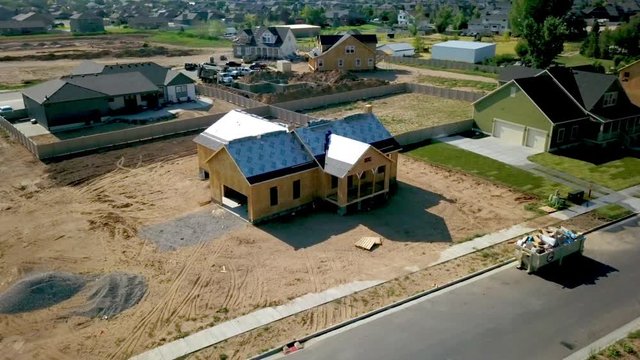 A drone shot spinning around a new home about to get shingles put on her roof.