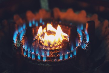 Blue fire flame. burning gas stove burner hob in the kitchen. natural resource and Energy saving...
