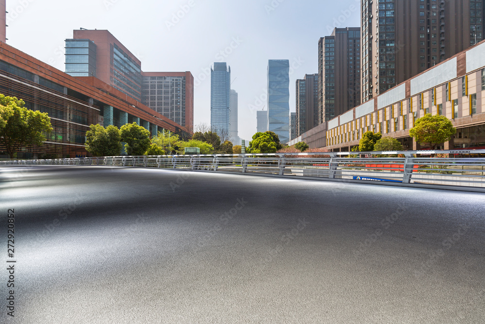 Wall mural Panoramic skyline and modern business office buildings with empty road,empty concrete square floor