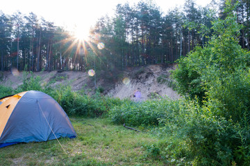 Photography in the evening hour of nature in the summer on a sunny day. Tent for travel.