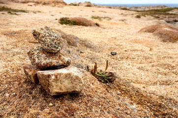 Stacked rocks on sandy beach